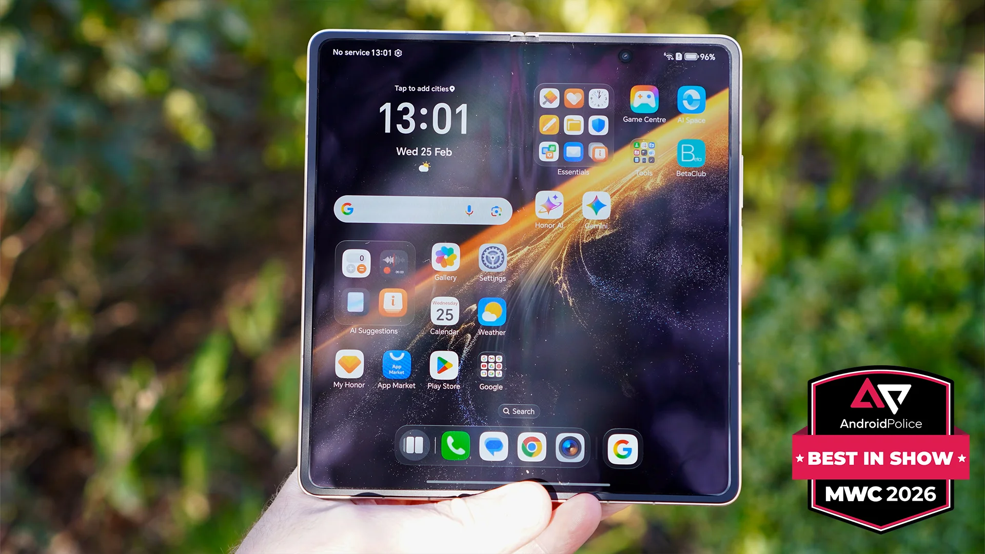 A hand holding the Honor Magic V6 showing the internal, unfolded screen